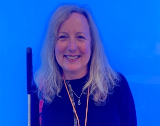 Sheri Albers against a bright blue background