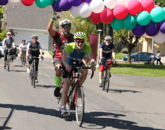 Tandem team David and Edwin ride their bike among four other bikers at Cycle for Sight in 2019