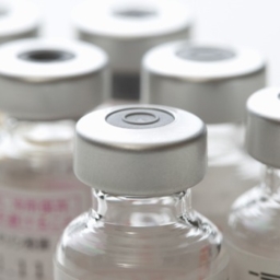 Close up image of a group of sealed glass bottles containing the vaccine