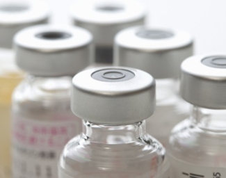 Close up image of a group of sealed glass bottles containing the vaccine