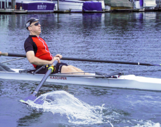 Chris Downey in a rowboat. Photo by Doug Olson, photographer
