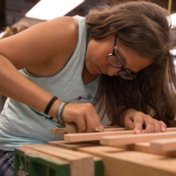 EHC teen camper working on a wood working project