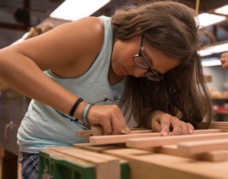 EHC teen camper working on a wood working project