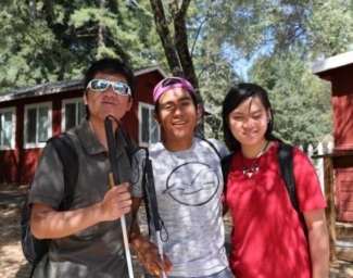 Teens pose in front of the cabins at EHC