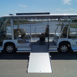 Giving Tuesday Shuttle A white electric shuttle bus with wheelchair ramp extended