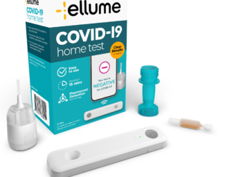 An image of several COVID-19 at-home test packages in a pile on a table.