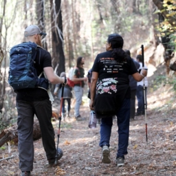 ehc hikers A group of people with white canes hike a trail at Enchanted Hills Camp