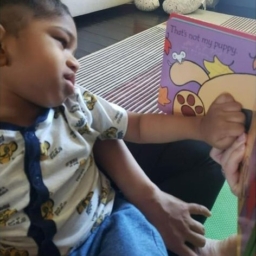 LightHouse Little Learner explore teh textures of a Braille book