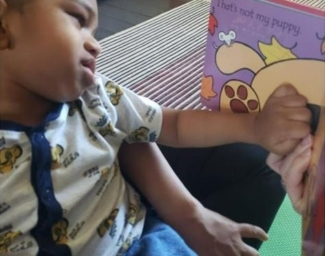 LightHouse Little Learner explore teh textures of a Braille book