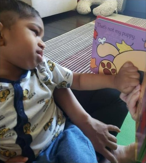 LightHouse Little Learner explore teh textures of a Braille book