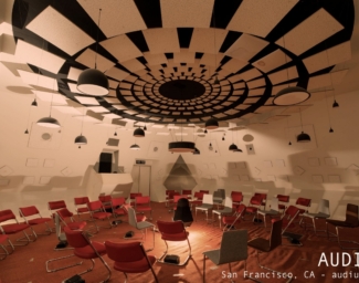 The Audium theater: chairs sit in a circle below a ceiling filled with 360 degrees of speakers