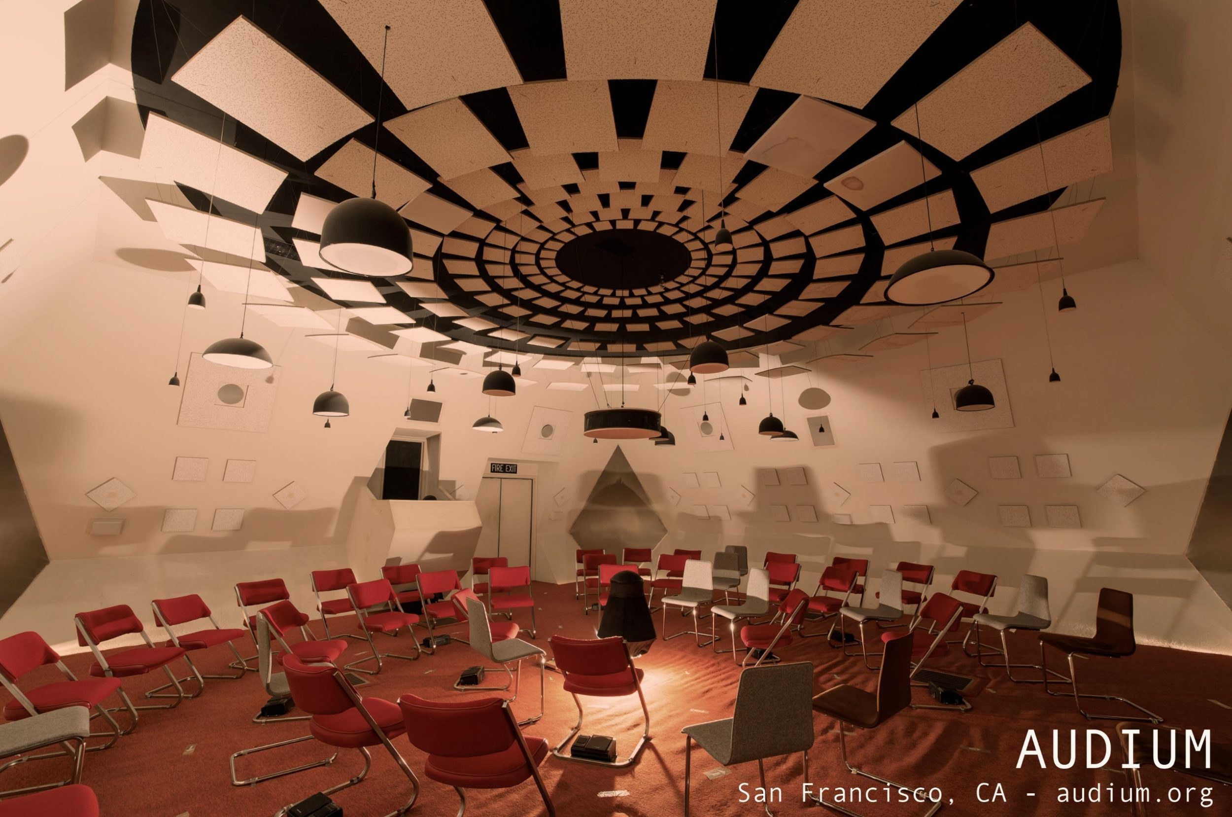 The Audium theater: chairs sit in a circle below a ceiling filled with 360 degrees of speakers