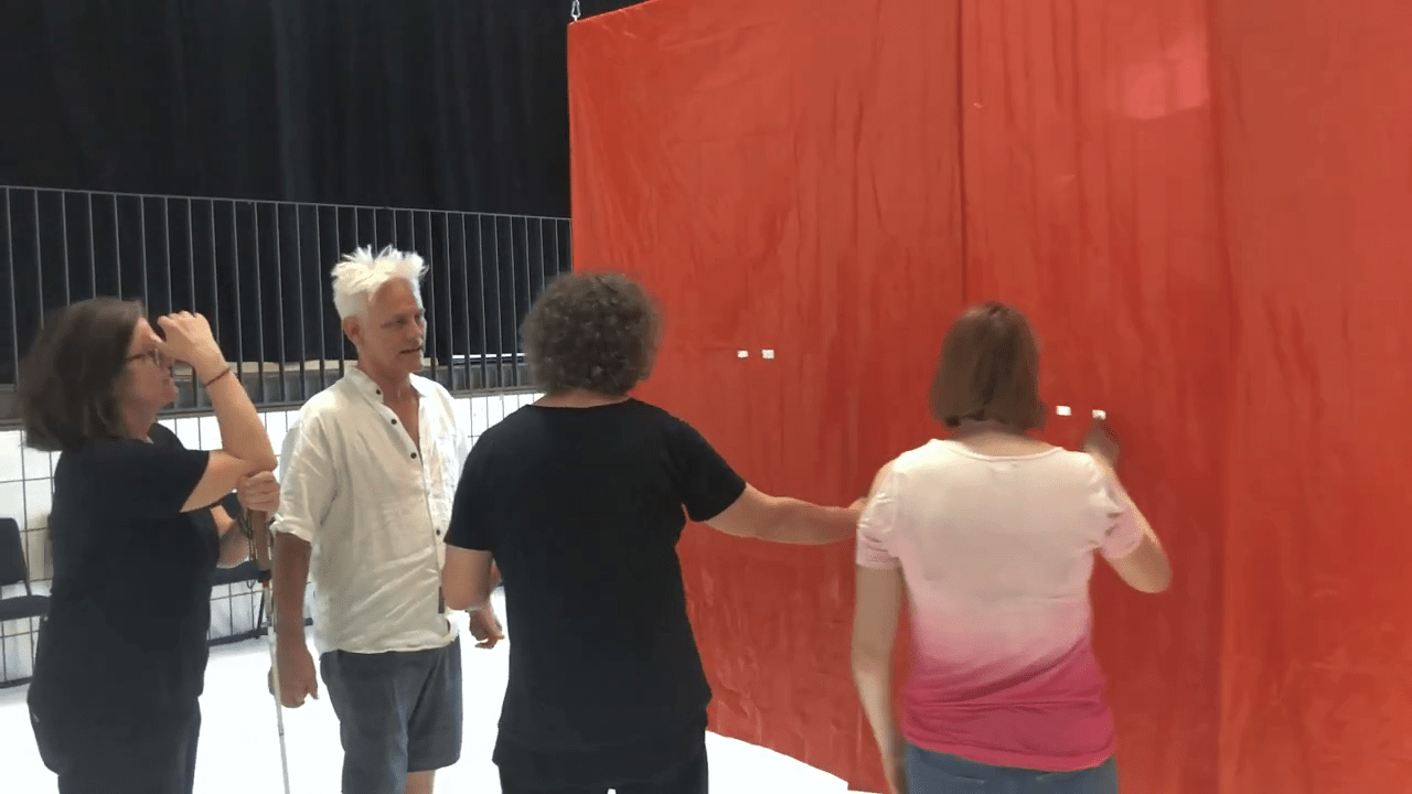 Jess Curtis explains the design of a show curtain during a haptic access tour