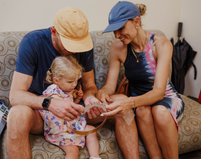 Hunter, Amanda and Little Learner sit on a couch