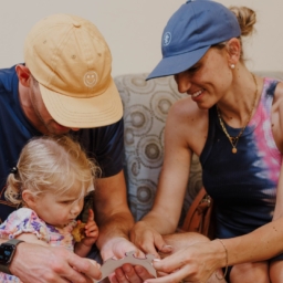 Hunter, Amanda and Little Learner sit on a couch