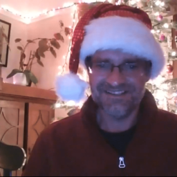 A Zoom screenshot of Camp Director Tony Fletcher wearing a Santa hat