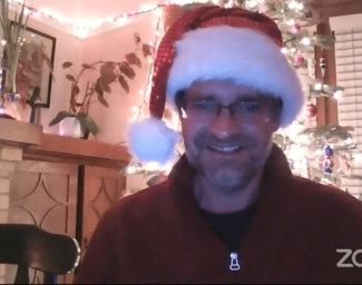 A Zoom screenshot of Camp Director Tony Fletcher wearing a Santa hat