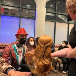Frozen preshow LightHouse student Carol touches a wig used in FROZEN the musical