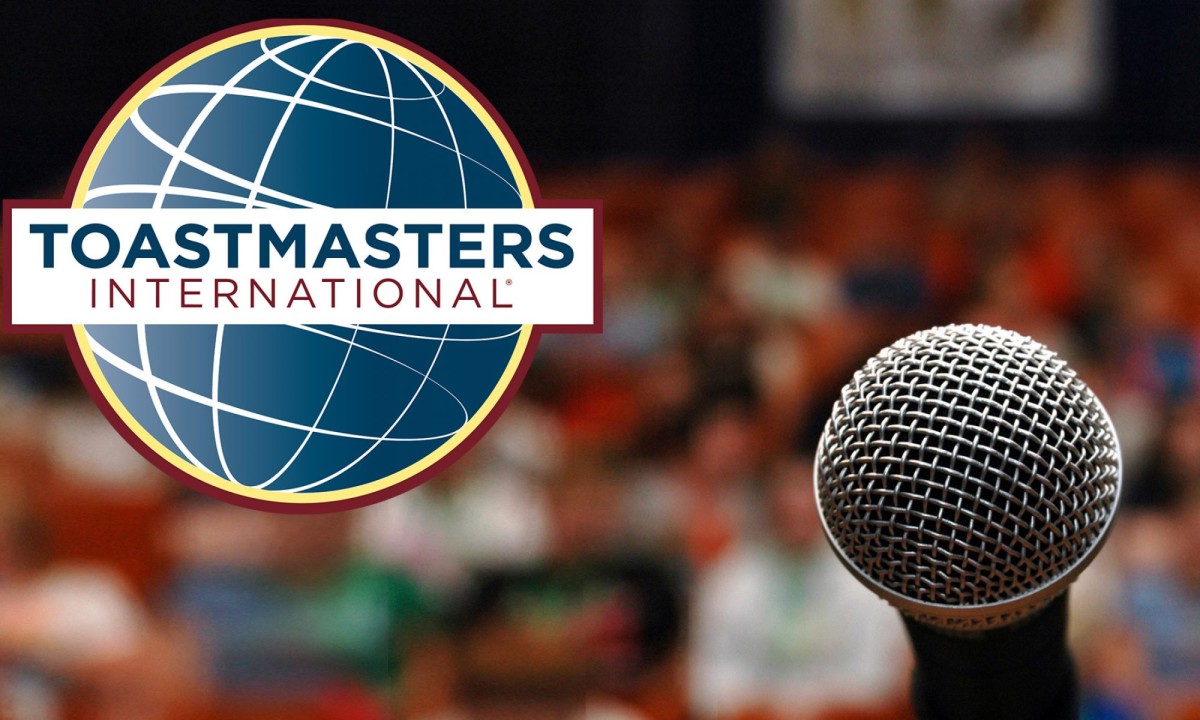 A microphone coupled with the Toastmasters logo, a stylized globe with the words “Toastmasters International” over it