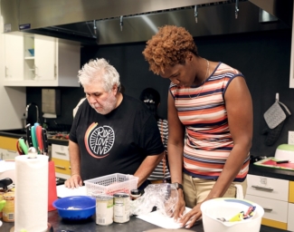 Bobbi Pompey, right, works in the LightHouse Training Kitchen with a student