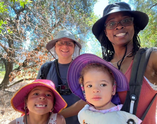 Little Learner Casey, Little Learner Mom Latasha and family smile while wearing sunhats in various colors