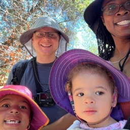 Little Learner Casey, Little Learner Mom Latasha and family smile while wearing sunhats in various colors