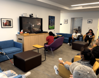 A LightHouse student plays a video game while others observe