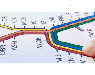 A finger explores a tactile BART system map.