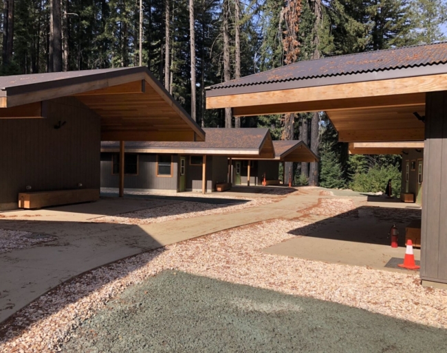 The exterior of the family cabins with paved paths leading through the area from cabin to cabin